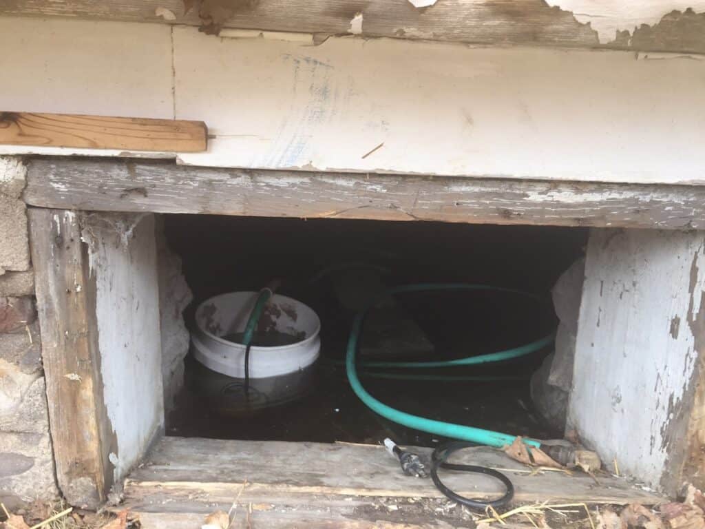 Before work on the foundation could begin, thousands of gallons of water were pumped from beneath the building. A pump in a temporary sump was used accomplish this.