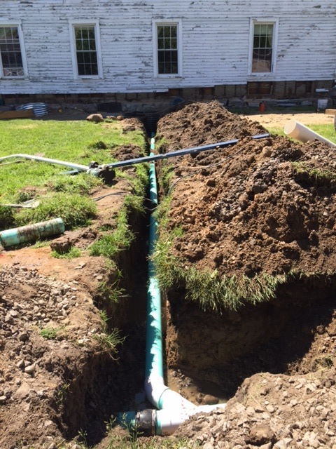 A gravity drain is being installed from the sump to the existing drainage system.