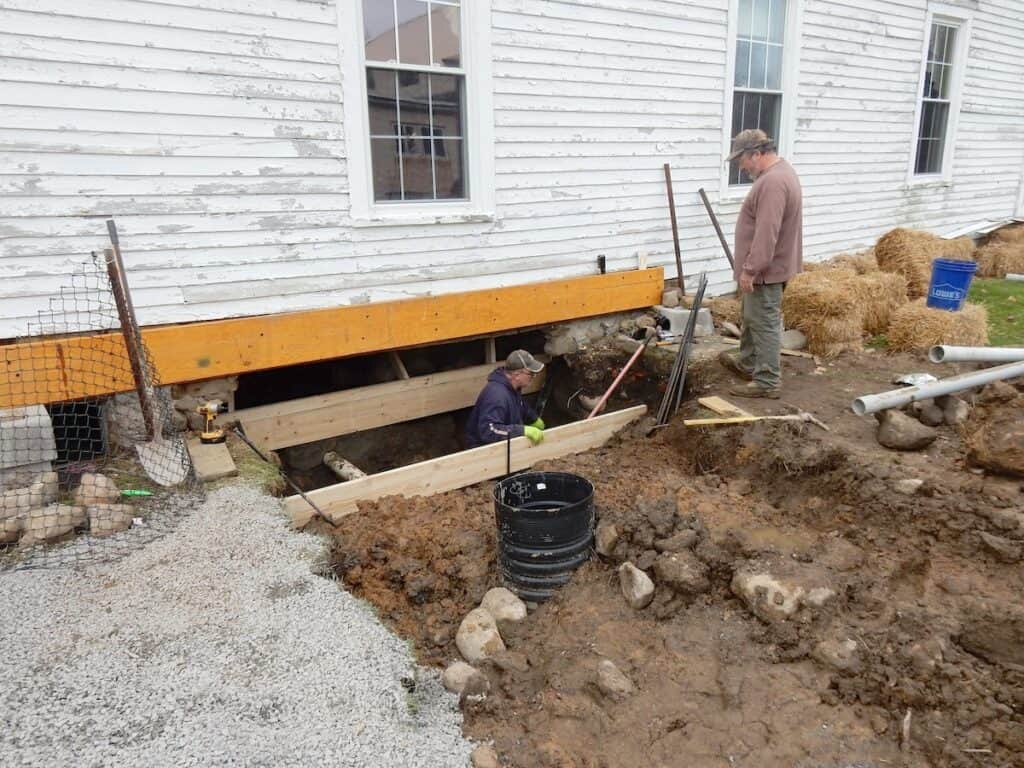 Mike (standing) and his brother Matt are building the form. The drain pipe that runs to the sump can be seen.