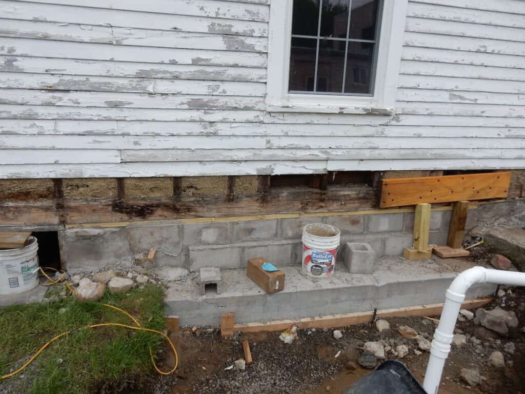 After the wall is lifted, cement blocks are placed to support the wall.