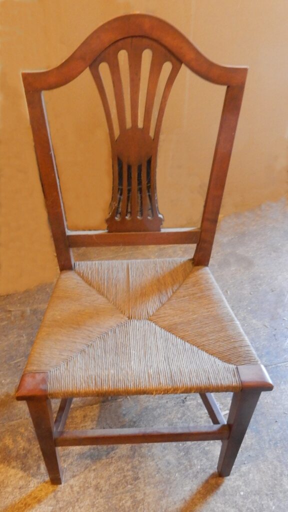 A chair with a seat made from rush.